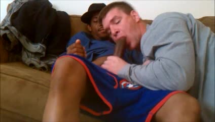 White horny stud sucking off a huge black cock on his sofa