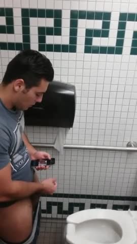 Caught a handsome guy stroking his cock in the toilet